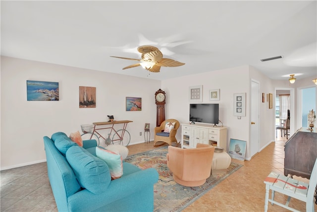 living room featuring light tile patterned floors and ceiling fan