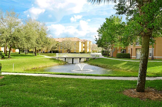 view of community featuring a yard and a water view