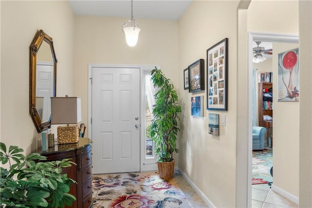 tiled entryway with ceiling fan