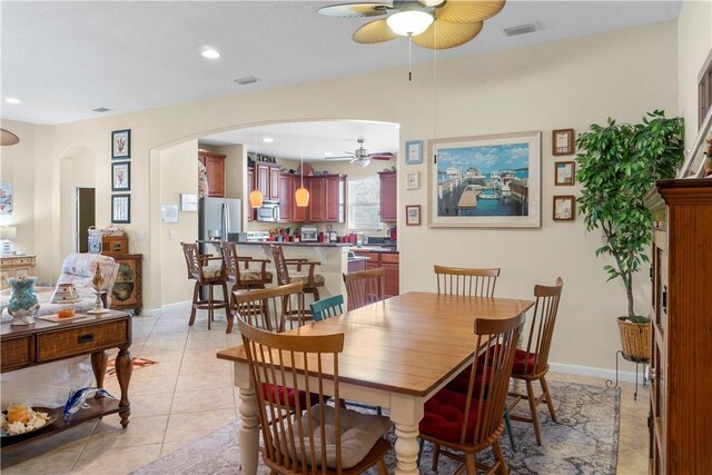 tiled dining space featuring ceiling fan