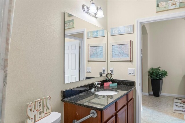 bathroom featuring vanity, toilet, and a chandelier