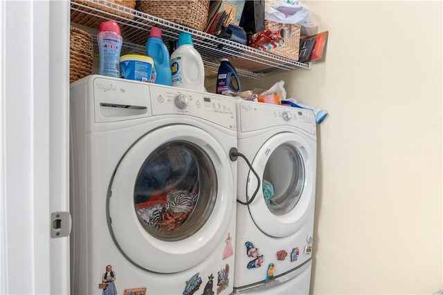 clothes washing area with washing machine and clothes dryer