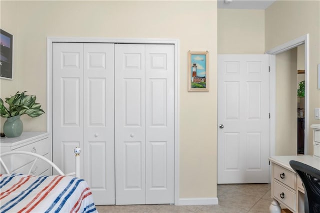 bedroom featuring light tile patterned floors and a closet