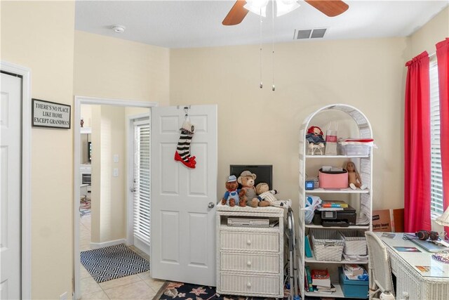 interior space featuring light tile patterned floors and ceiling fan