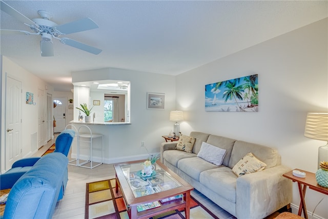 living room with ceiling fan and light wood-type flooring