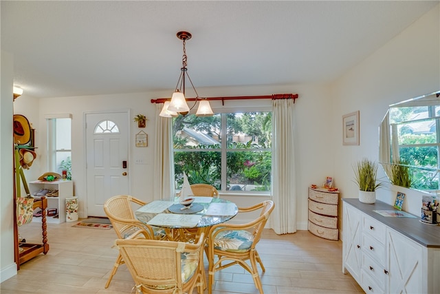 dining space with a wealth of natural light and light hardwood / wood-style flooring