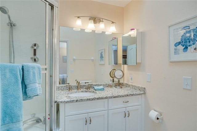 bathroom with walk in shower and vanity