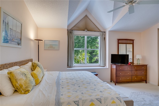 carpeted bedroom with a textured ceiling, ceiling fan, and vaulted ceiling