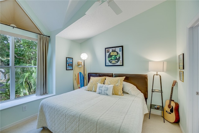 bedroom featuring lofted ceiling, light carpet, and ceiling fan