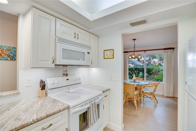 kitchen featuring white cabinetry, decorative light fixtures, white appliances, light hardwood / wood-style flooring, and a notable chandelier