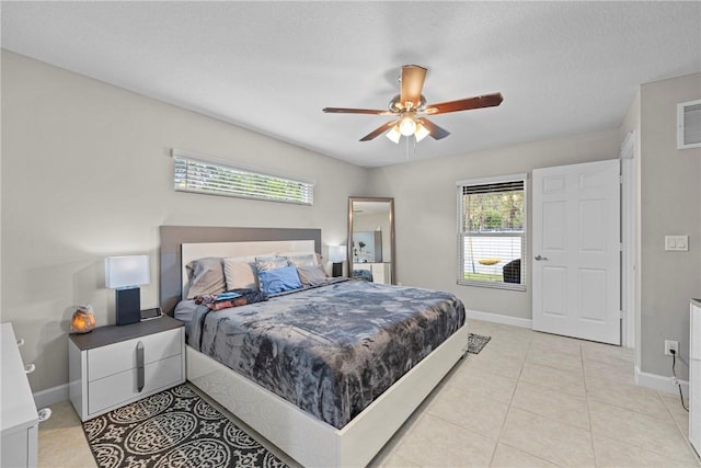 tiled bedroom with ceiling fan