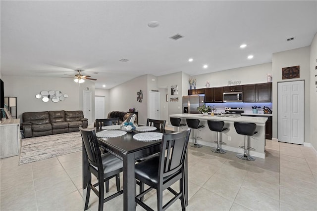 tiled dining space featuring ceiling fan