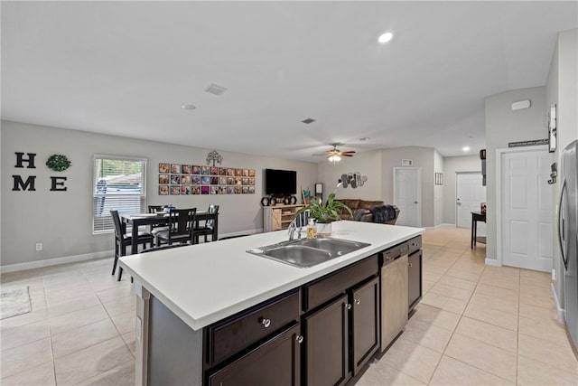 kitchen with dark brown cabinetry, ceiling fan, sink, an island with sink, and light tile patterned floors