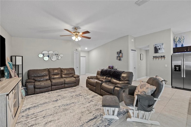 living room with light tile patterned floors, a textured ceiling, and ceiling fan