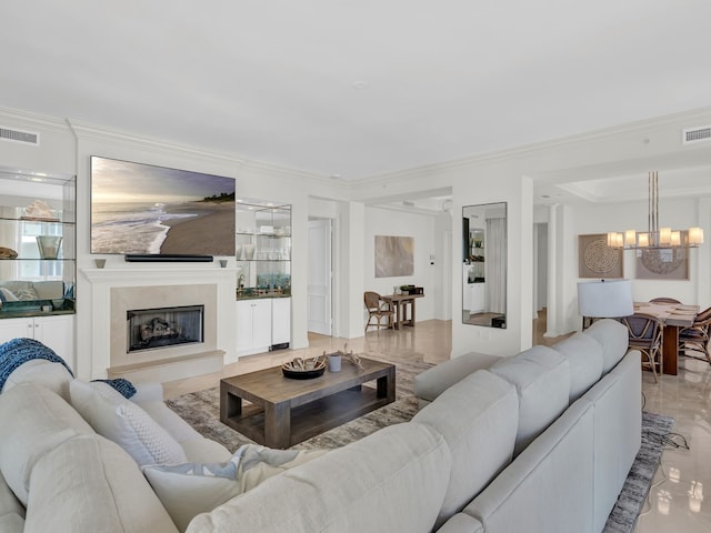 living room with a notable chandelier and ornamental molding