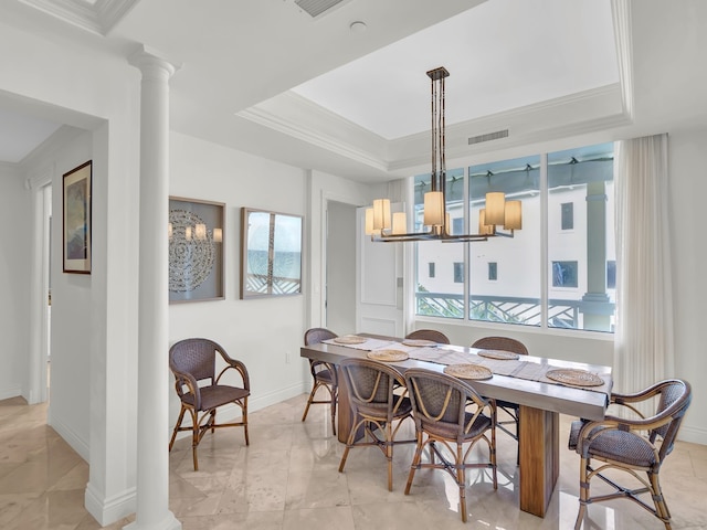 600 Beachview Dr Unit 3N, Vero Beach, FL 32963 - dining area featuring decorative columns, a chandelier, a tray ceiling, ornamental molding, and baseboards