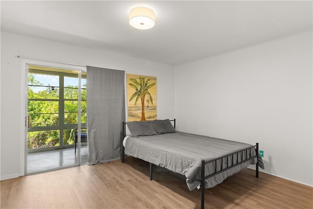 51 Woodland Dr Unit 207, Vero Beach, FL 32962 - bedroom with wood finished floors and access to outside