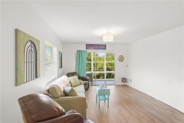 51 Woodland Dr Unit 207, Vero Beach, FL 32962 - living room with healthy amount of natural light and wood finished floors