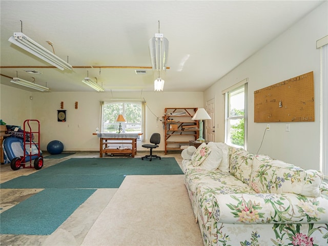 living room with plenty of natural light and carpet floors