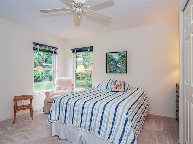 bedroom featuring light colored carpet and ceiling fan