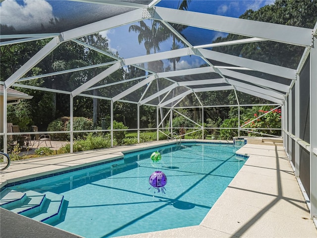 view of pool featuring a patio area and a lanai