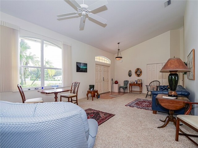 carpeted living room featuring lofted ceiling and ceiling fan