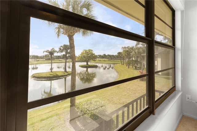 unfurnished sunroom featuring a water view