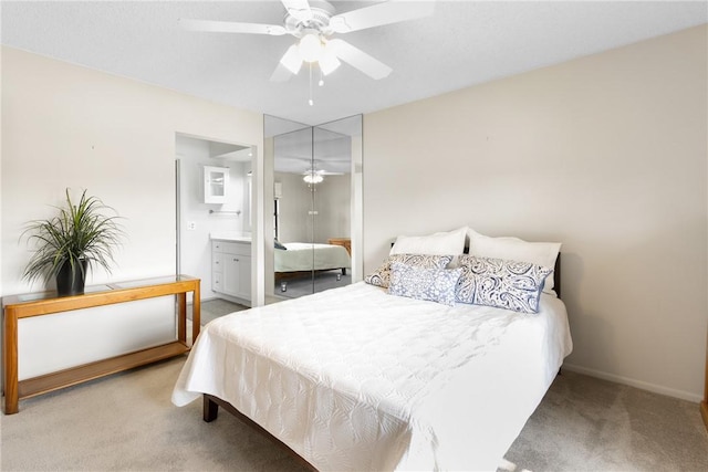 bedroom with a closet, carpet flooring, connected bathroom, and ceiling fan