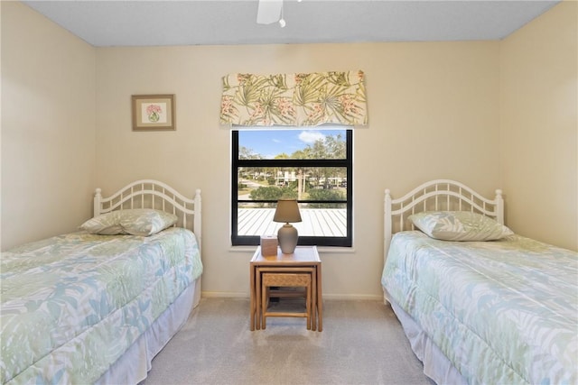 carpeted bedroom featuring ceiling fan and baseboards