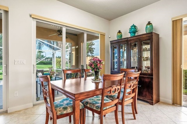 dining space with light tile patterned floors and ceiling fan