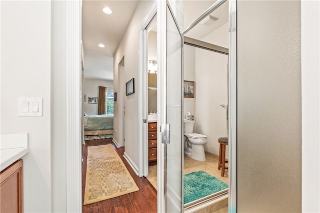 bathroom featuring vanity, toilet, and wood-type flooring