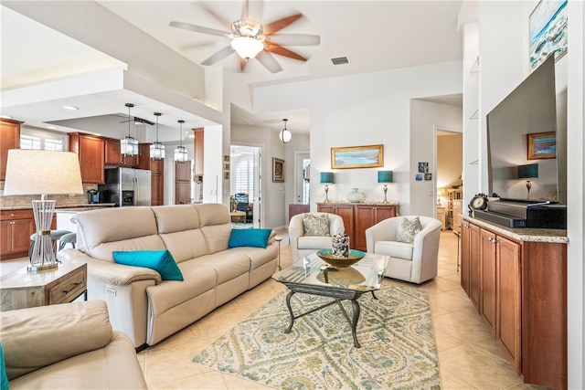 tiled living room with ceiling fan