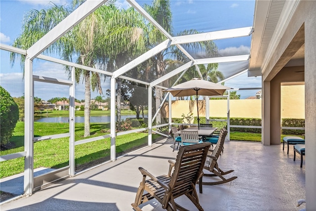 sunroom featuring a water view and a pool