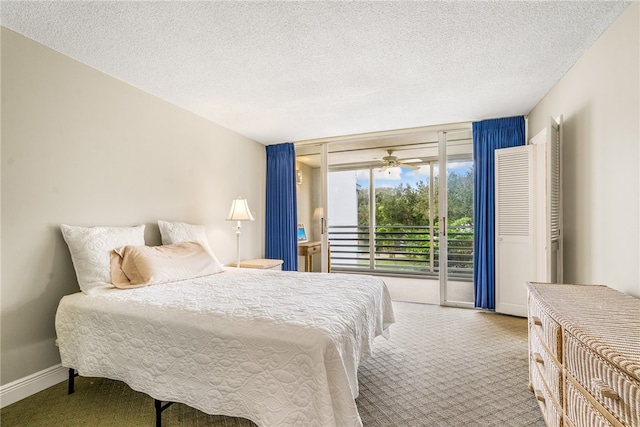 carpeted bedroom with access to exterior and a textured ceiling