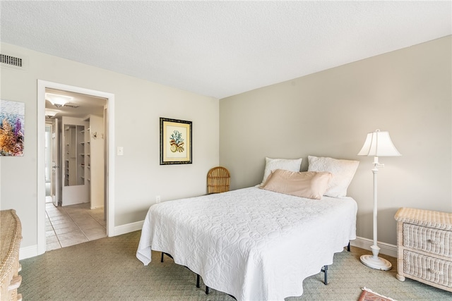 tiled bedroom with a textured ceiling