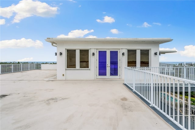 exterior space featuring a swimming pool, french doors, and a patio area