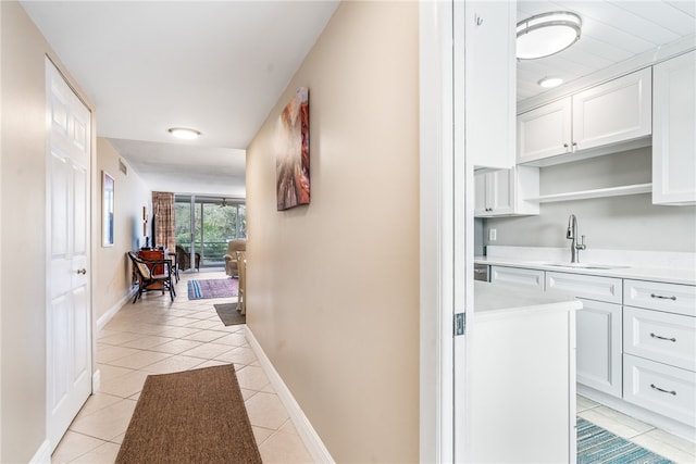 hall with light tile patterned flooring and sink