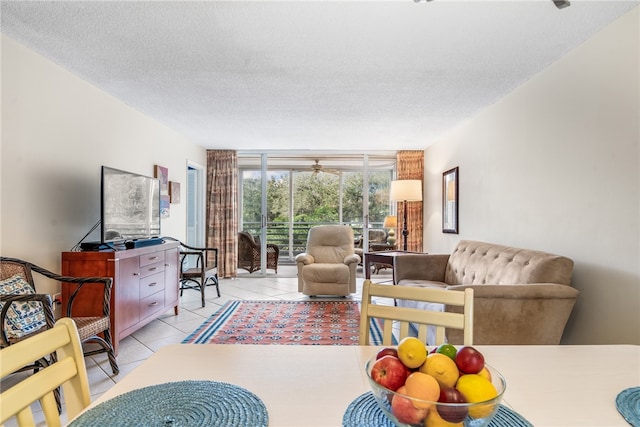 living room with a textured ceiling and light tile patterned flooring