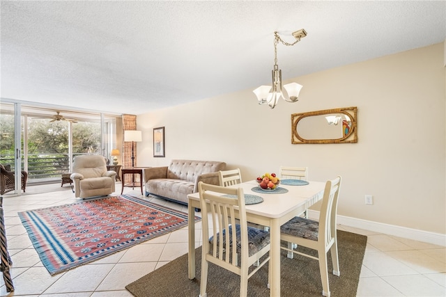 dining room with a textured ceiling, light tile patterned floors, and a notable chandelier