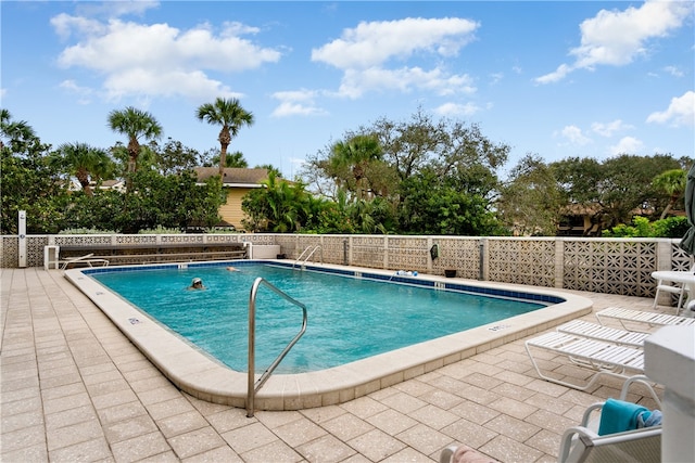 view of swimming pool featuring a patio area