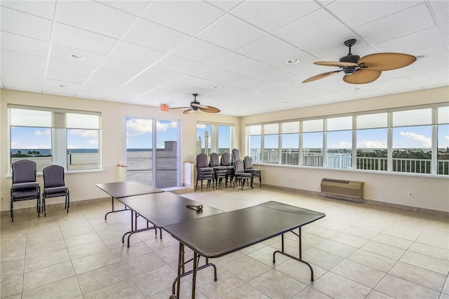 game room with a healthy amount of sunlight, ceiling fan, and light tile patterned flooring