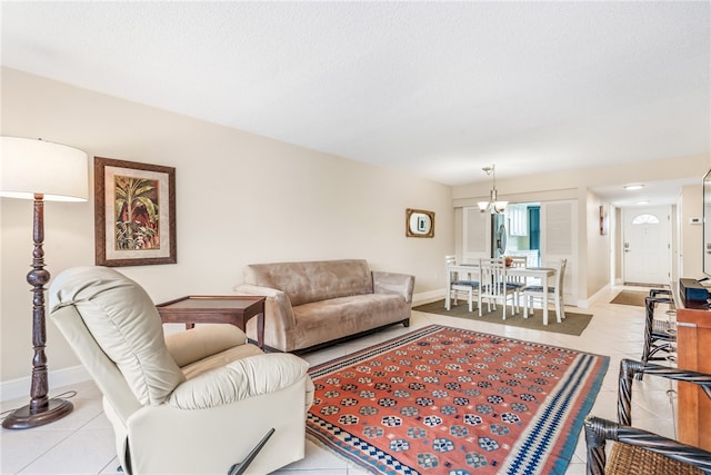 living room featuring a textured ceiling, light tile patterned floors, and a notable chandelier