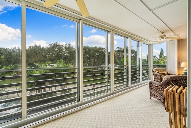 sunroom featuring ceiling fan