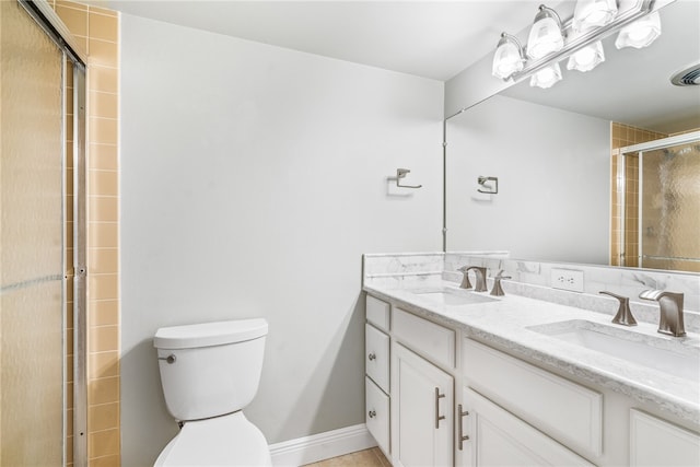 bathroom featuring an enclosed shower, vanity, and toilet