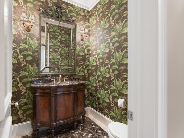 bathroom featuring vanity, toilet, and crown molding