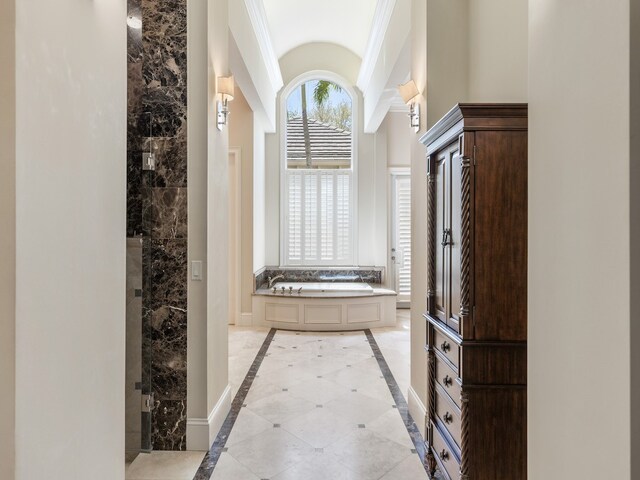 bathroom with tile patterned floors, a bathing tub, and crown molding