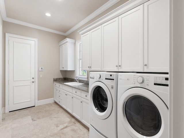 washroom with cabinets, washer and clothes dryer, sink, and crown molding