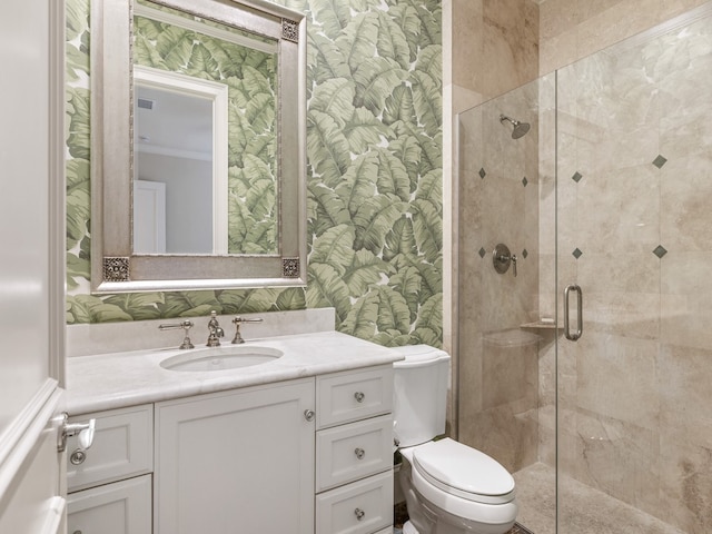 bathroom with vanity, toilet, and a shower with shower door