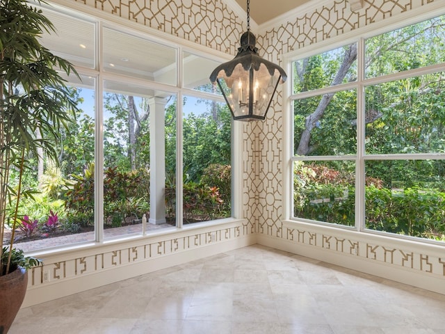 unfurnished sunroom with an inviting chandelier