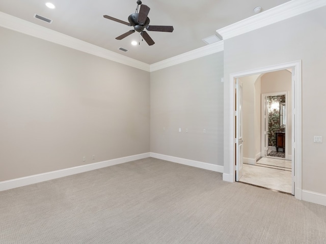 carpeted empty room featuring ceiling fan and crown molding